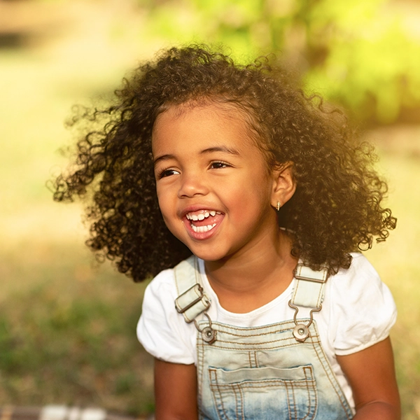 Girl In Overalls In Field