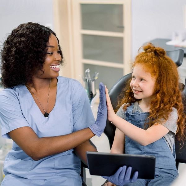Red Haired Girl High Fiving Her Dentist