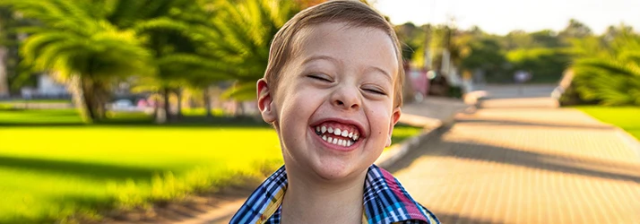 Young Boy Smiling Outdoors